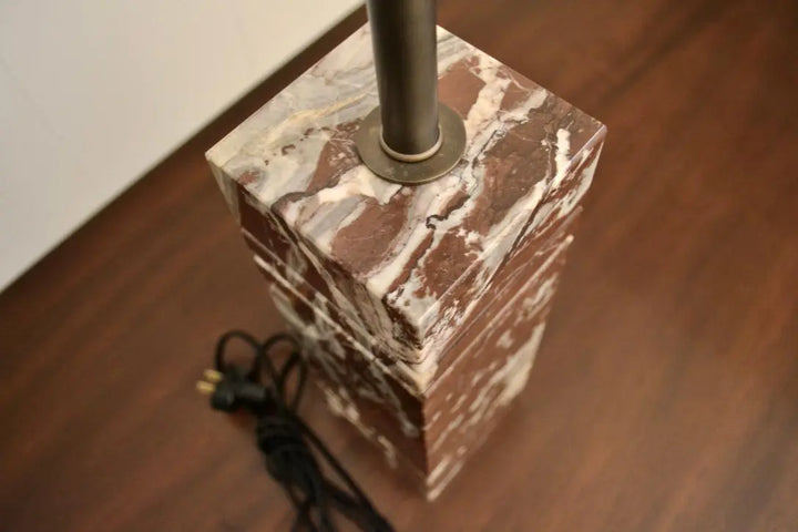 Top-down detail of red marble lamp showing polished surface and socket mount