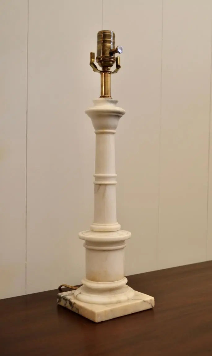 Front view of a neoclassical alabaster urn table lamp with brass socket