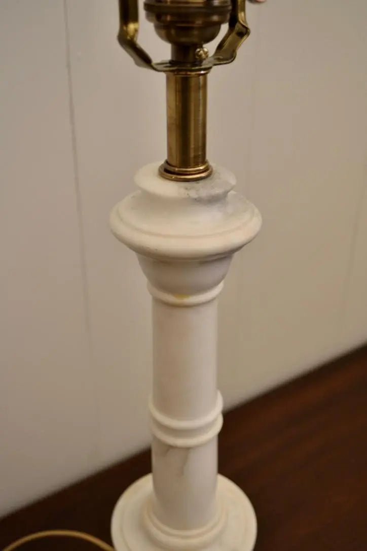 Angled view of a neoclassical alabaster urn table lamp showing twisted cloth cord