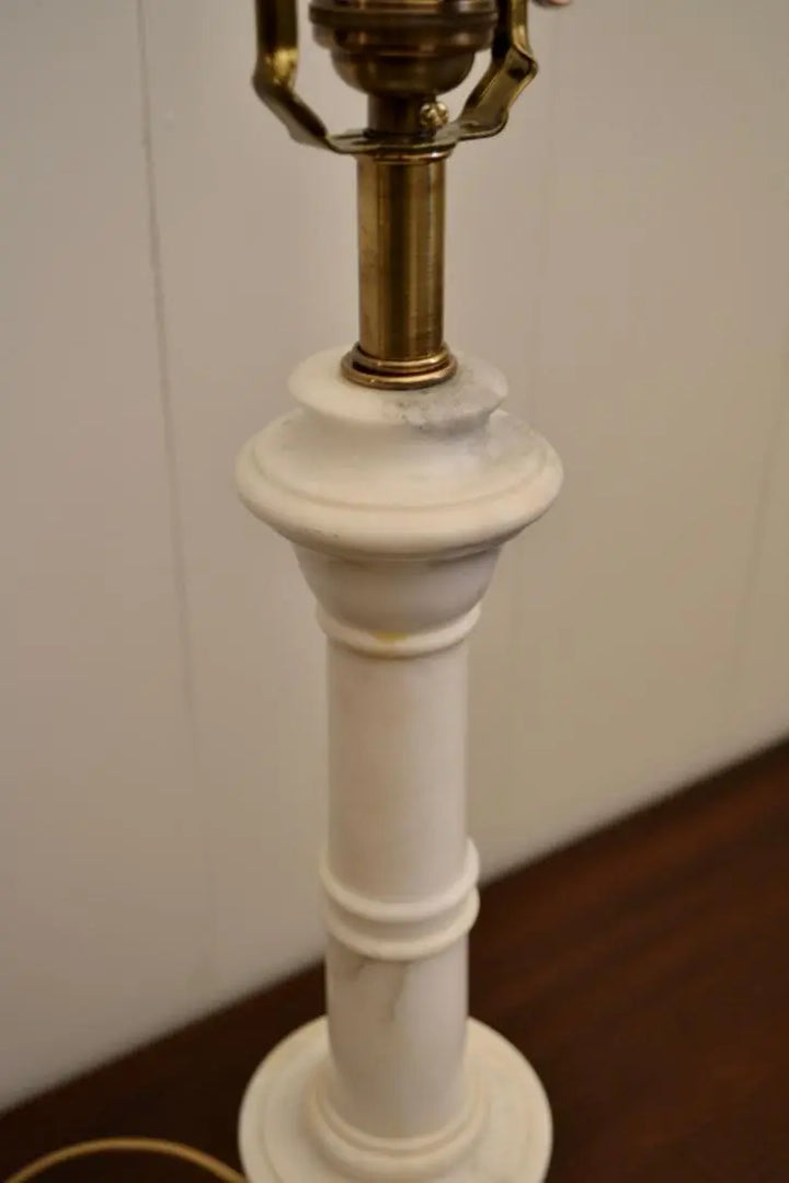 Angled view of a neoclassical alabaster urn table lamp showing twisted cloth cord