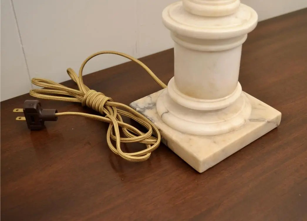 Close-up of brass socket and alabaster finial on a neoclassical urn lamp