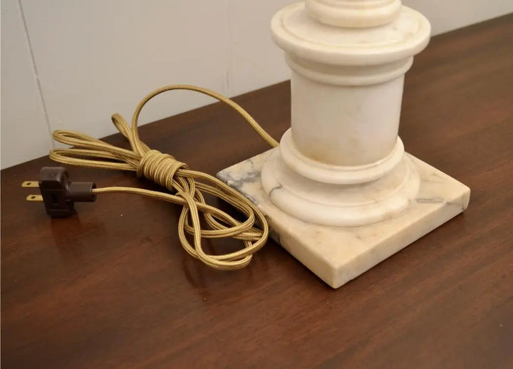 Close-up of brass socket and alabaster finial on a neoclassical urn lamp