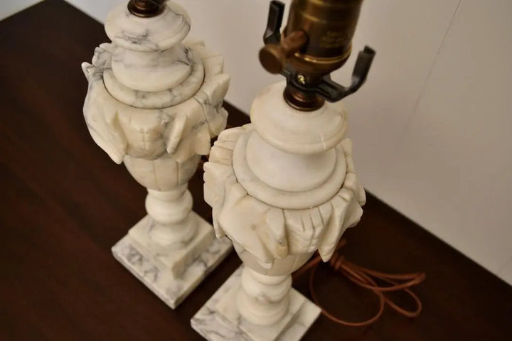 Top angle view of vintage carved white marble table lamps showing leaf detailing and sockets