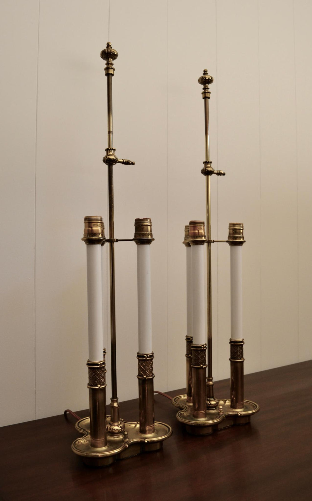 Pair of antique brass taper candle holders with burgundy candles