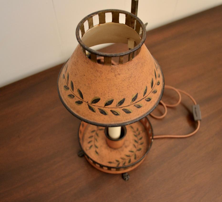 Overhead view of red Bouillotte-style lamp with vented shade and decorative olive branch detailing