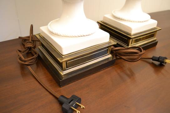Close-up of brass bases and power cords on Frederick Cooper white ceramic lattice urn table lamps.