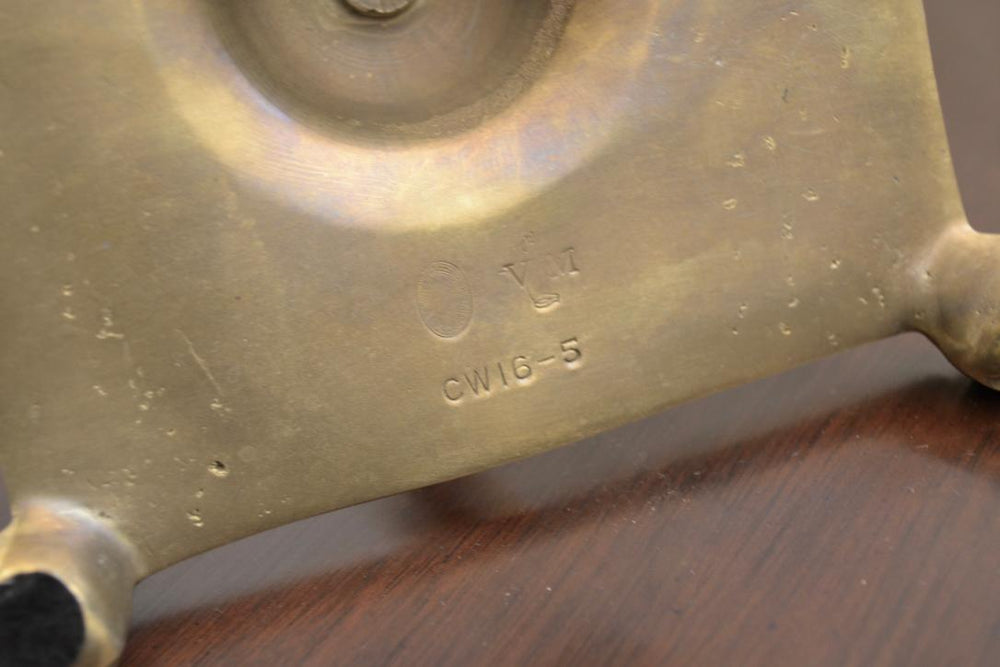 Maker’s mark on bottom of brass candlestick holder showing stamped code CW16-5.