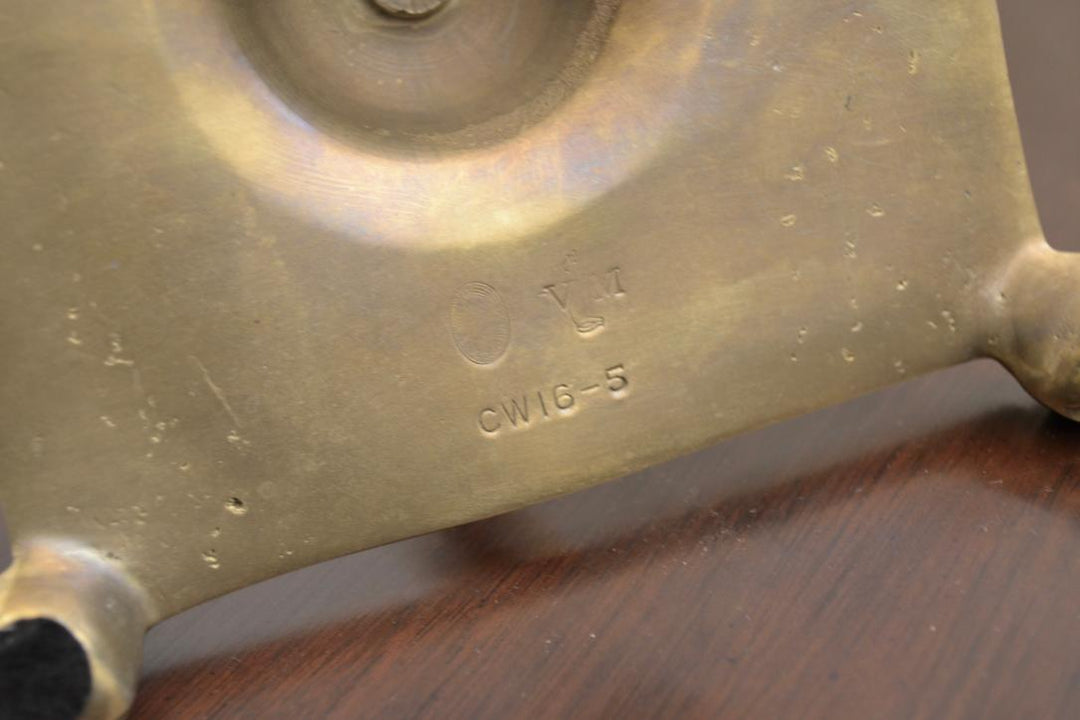 Maker’s mark on bottom of brass candlestick holder showing stamped code CW16-5.