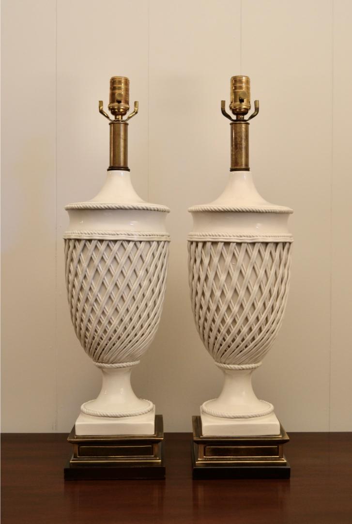 Front view of Frederick Cooper white ceramic urn lamps with lattice design and elegant brass pedestal bases.