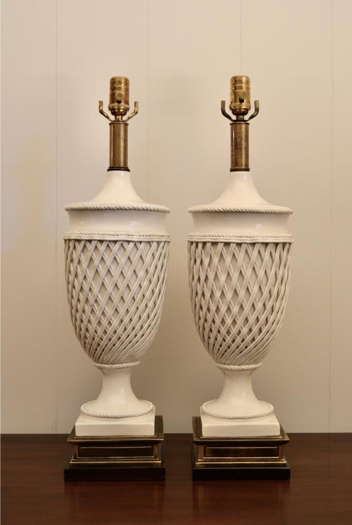 Front view of Frederick Cooper white ceramic urn lamps with lattice design and elegant brass pedestal bases.
