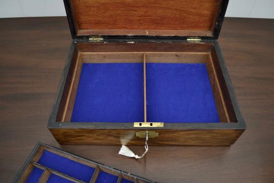 Open antique mahogany and brass jewelry box with deep blue velvet lining and center divider