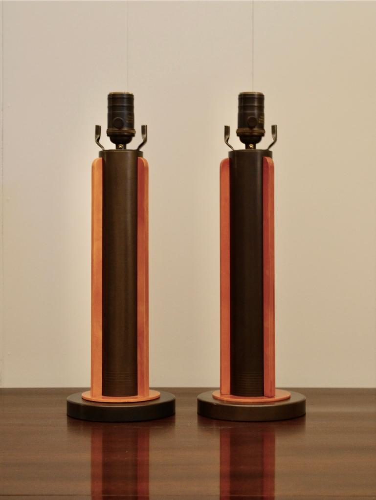 Pair of modern industrial-style table lamps featuring dark metal columns and warm-toned wooden accents