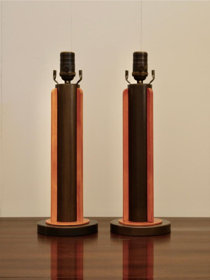 Pair of modern industrial-style table lamps featuring dark metal columns and warm-toned wooden accents