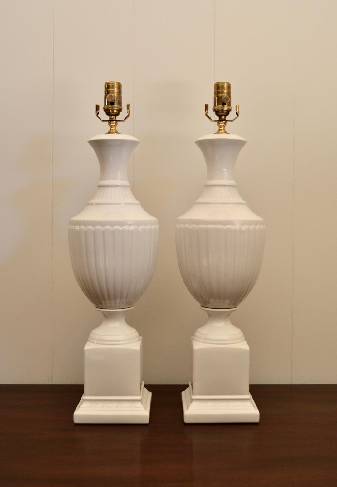 Pair of vintage white ceramic urn table lamps with fluted bodies and square bases