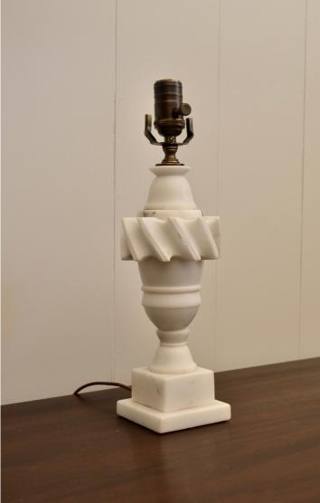Angled side view of vintage white marble lamp with carved swirl detail and square base