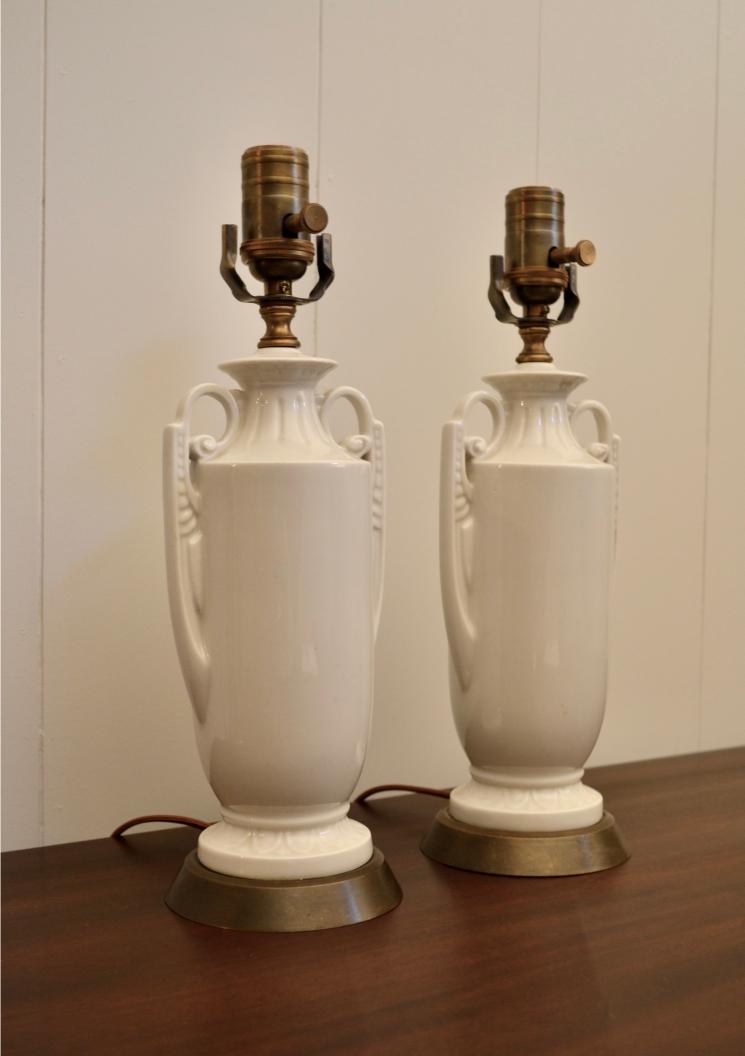 Side angle of white ceramic urn table lamps with ornate handle design