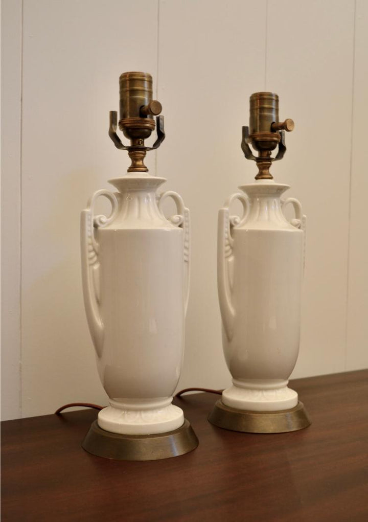 Side angle of white ceramic urn table lamps with ornate handle design