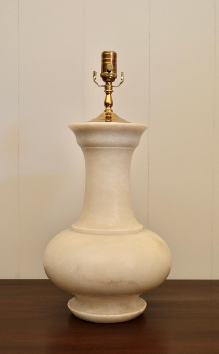 Full frontal view of large alabaster table lamp with flared neck and wide body