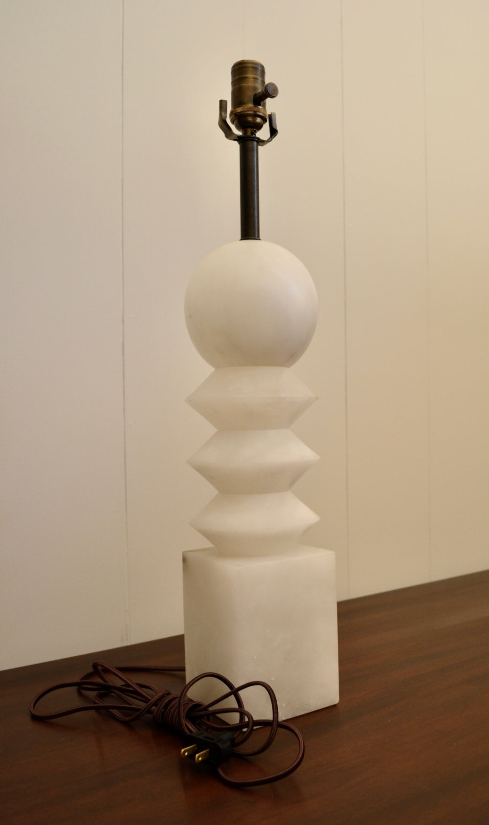 Vintage alabaster table lamp with sculptural geometric design and visible brown cloth cord