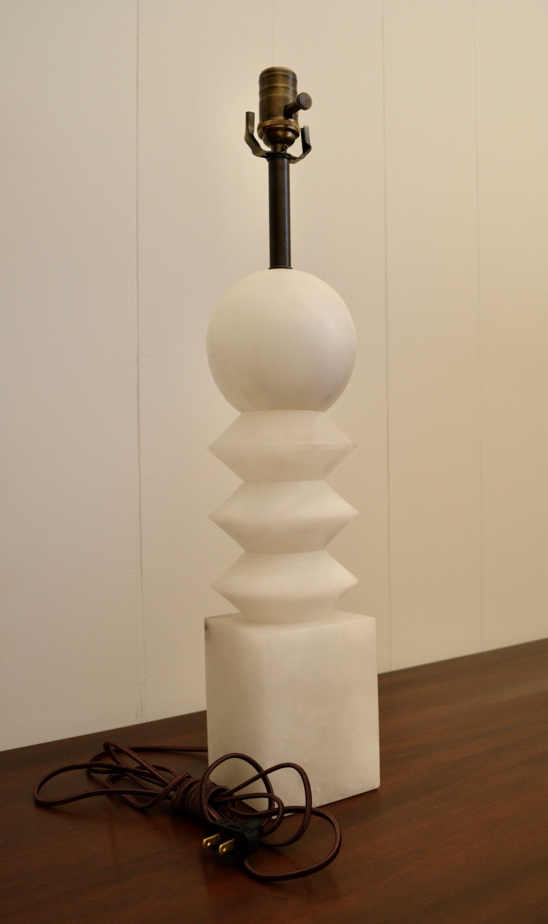 Vintage alabaster table lamp with sculptural geometric design and visible brown cloth cord