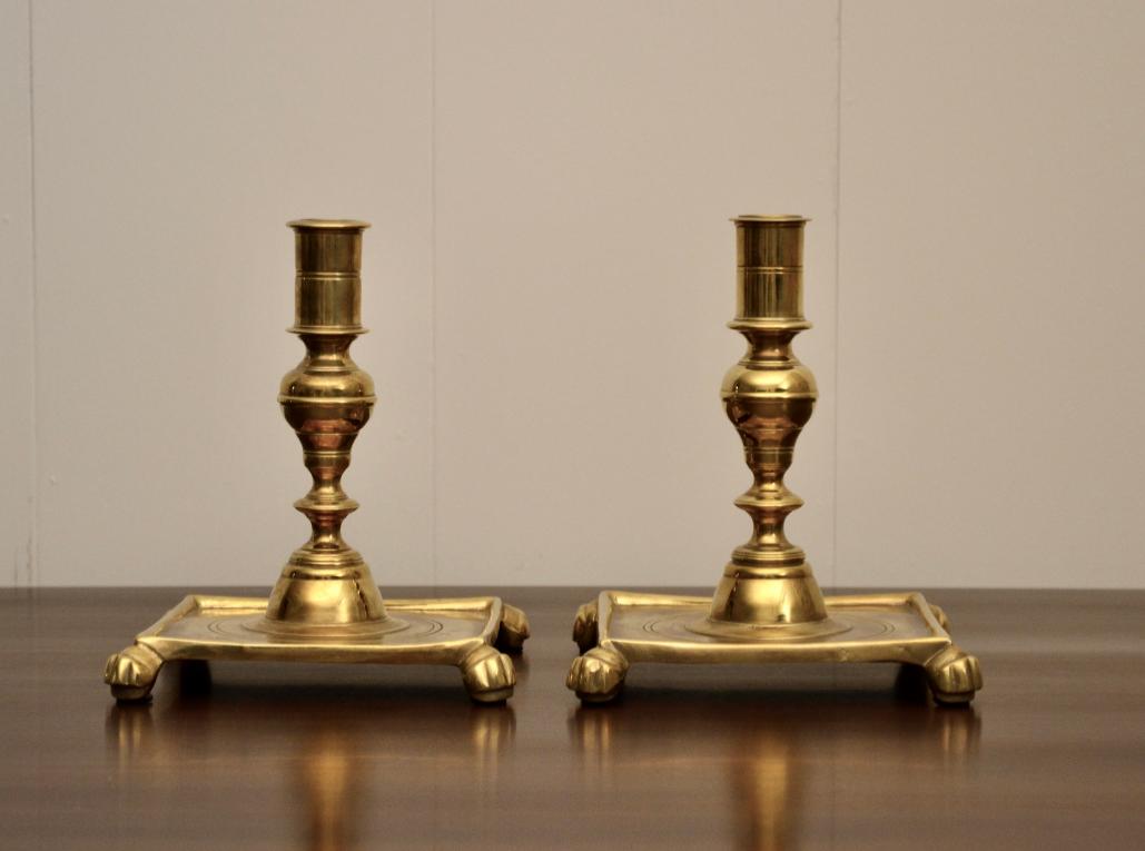 Pair of vintage brass candlestick holders with square claw foot bases