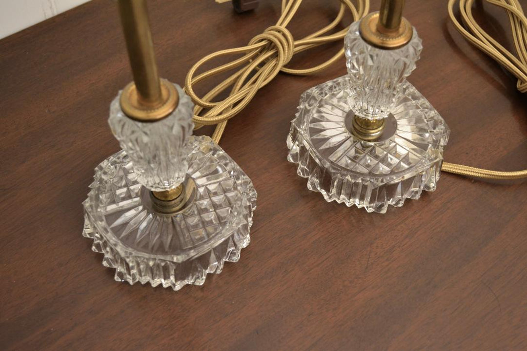 Close-up_of_two_vintage_crystal_and_brass_lamp_bases_with_gold_cords