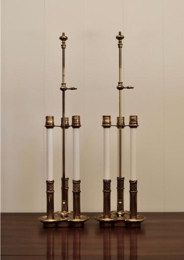 Pair of vintage cut glass and brass table lamps with detailed bases.