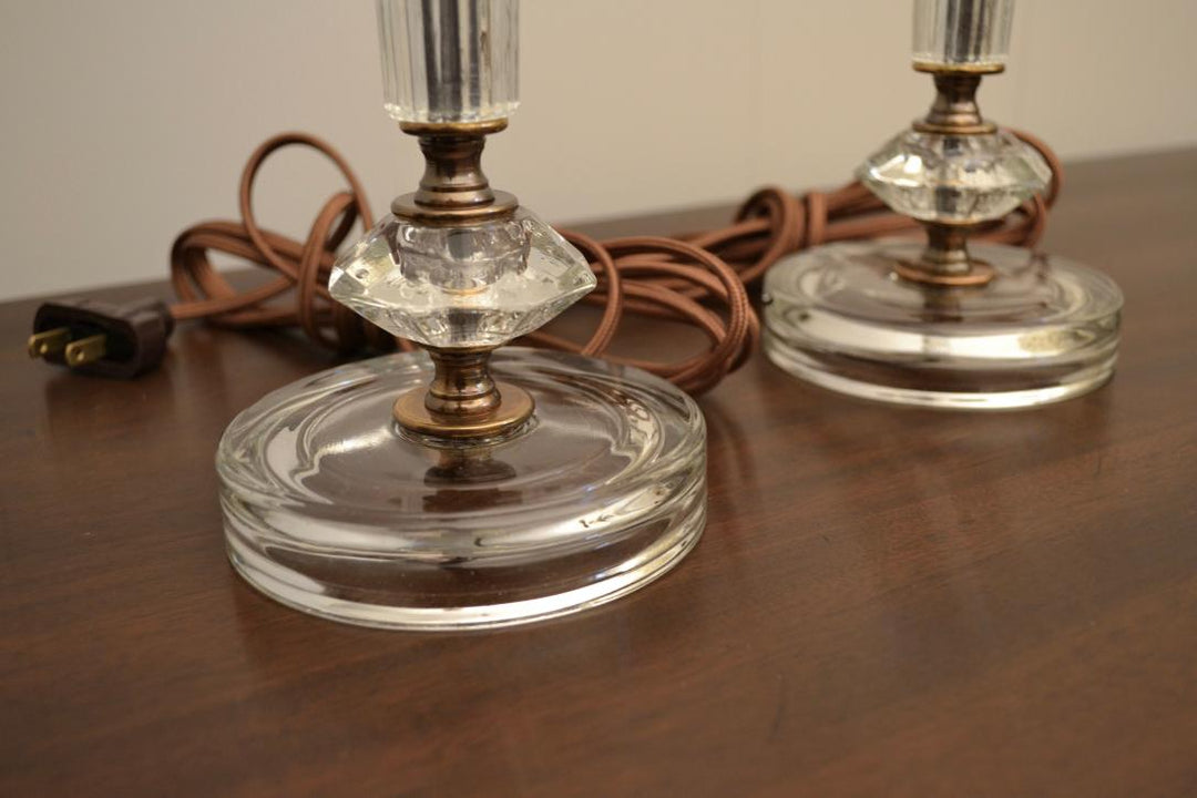 Close-up of clear glass lamp base with faceted diamond-shaped detail and brown power cord