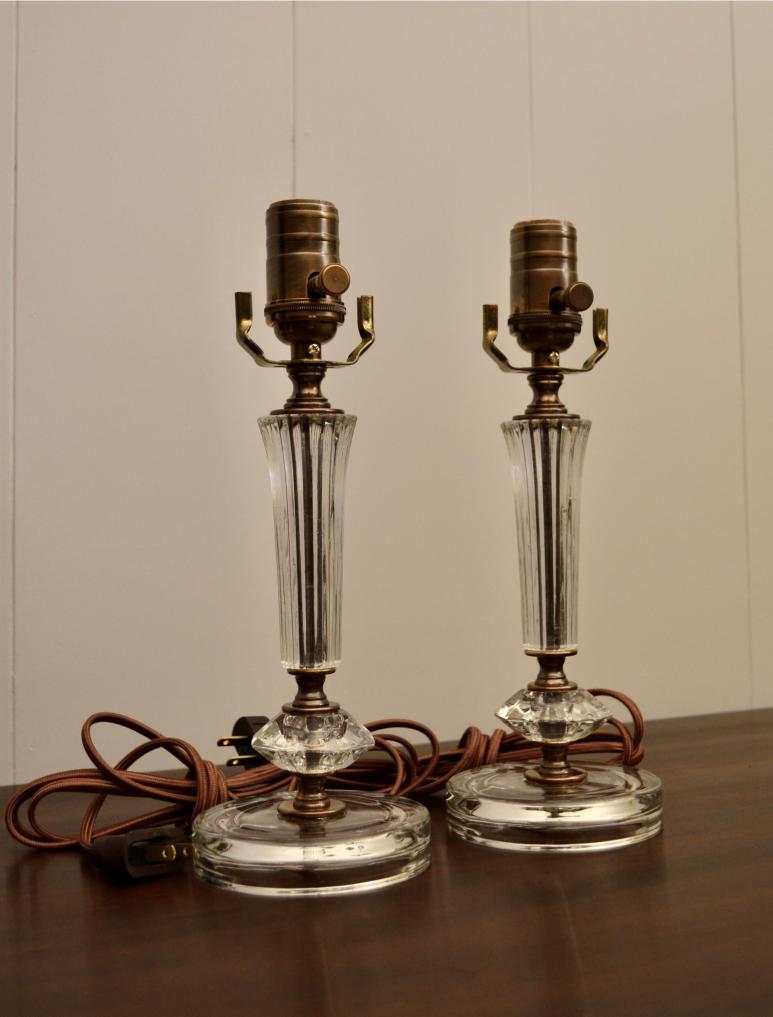 Pair of vintage clear glass lamps with brass sockets and brown cloth cords