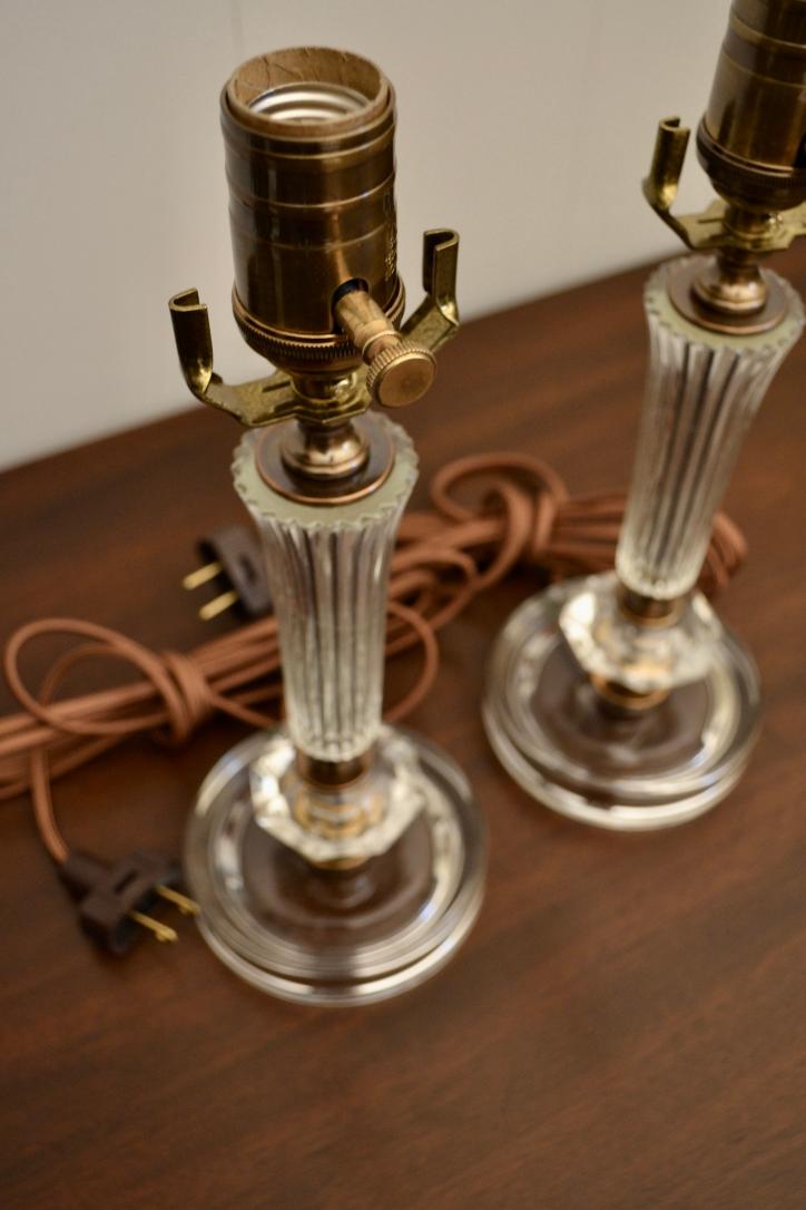 Top view of fluted glass lamp columns with brass sockets and vintage-style brown power cords