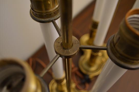 Close-up of brass socket atop a white ceramic urn lamp